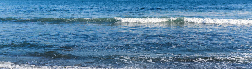 Naklejka na ściany i meble Waves at the seashore. Selective focus with shallow depth of field.