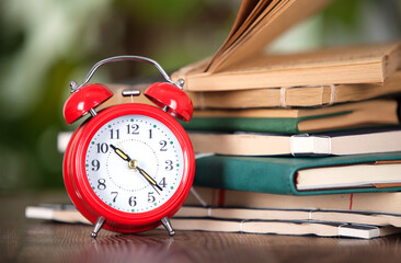 A stack of books and an alarm clock