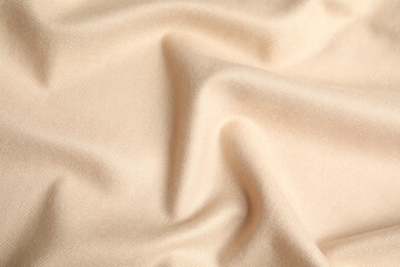 Fototapeta premium Beige soft cashmere fabric as background, closeup