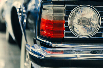 headlights of a car in black in the showroom.