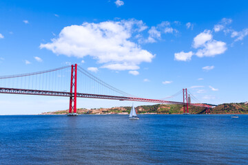 Fototapeta na wymiar Famous bridge in Lisbon over the Tagus river. Ponte 25 de Abril in Lisboa Portugal