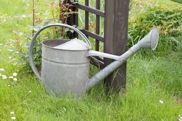 Metal watering can in garden