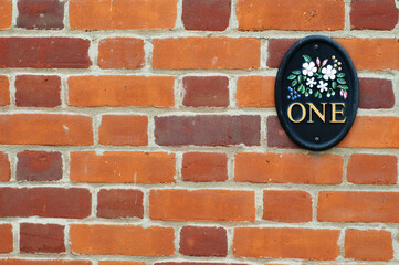 Number one plate on brick wall