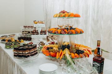 Buffet table with sweets and fruits.