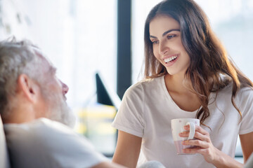 Close up of happy woman with coffee and man