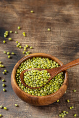 Mung. Green mung beans in a bowl on a brown wooden table. Legume plant for a healthy diet