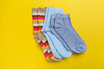 View from above. Socks are scattered on a yellow background. Clothing in the form of socks.