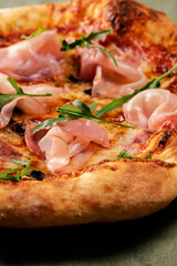 Homemade pizza with champignon mushrooms and ham