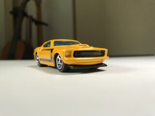 Fototapeta na wymiar Yellow and black sports muscle toy car