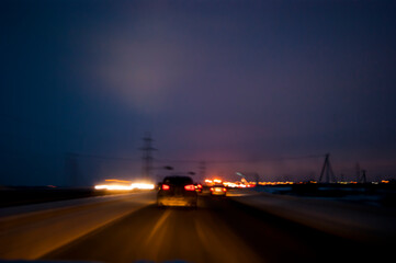 Light headlights in the dark, the movement of cars from the viewer