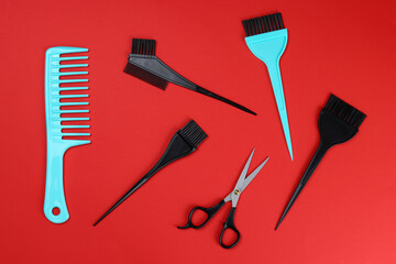 Tools of a professional hairdresser, barber on a red background