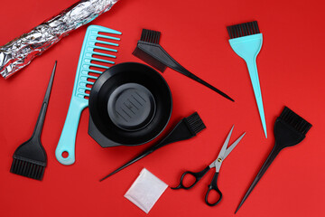 Tools for hair dye, for the hairdresser, topview on red background