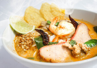 Thai Style Sour and Spicy Noodles Broth Soup with Shrimp, Prawn, Tomato, Mushroom, Kaffir Lime Leaves and Herbs. Tom Yam Kung Noodles Tom Yum Goong Noodels, close-up shot