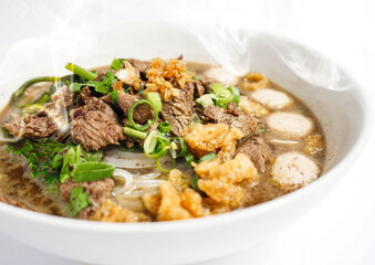 Thai Style Beef Boat Noodles with Meat balls and Crispy pork on top. Thai Broth Noodle Soup. Kuai Tiao Rua Kook Chin