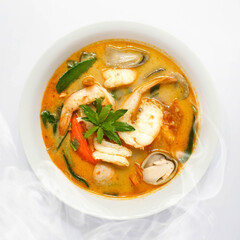 Thai Style Sour and Spicy Broth Soup with Shrimp, Prawn, Tomato, Mushroom, Kaffir Lime Leaves and Herbs. Tom Yam Kung Tom Yum Goong, Top shot