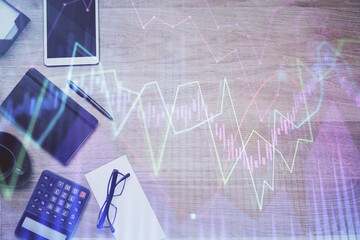 Double exposure of forex graph drawing and work table top veiw. Concept of financial analysis.