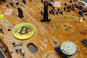 golden bitcoin coin on Printed circuit board. The concept of earning, mining cryptocurrency