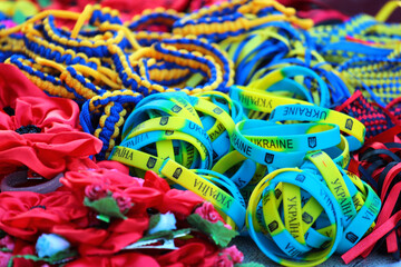 Ukrainian souvenirs in national blue and yellow colors at street market in Kyiv, Ukraine. Bracelets with word Ukraine in English and Ukrainian languages.