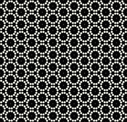 A pattern with white circles and small stars on a dark, dark background