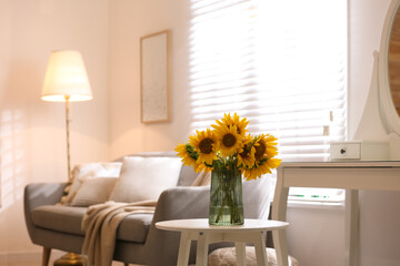 Beautiful bouquet of sunflowers in vase on white table indoors. Space for text