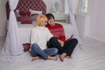 Young happy romantic couple spending time together at home near bed