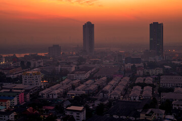 The high angle background of the city view with the secret light of the evening, blurring of night lights, showing the distribution of condominiums, dense homes in the capital community