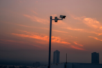 Blurred background of CCTV cameras installed along the condo's rooftop, to ensure the safety of residents and to maintain common property in modern times.