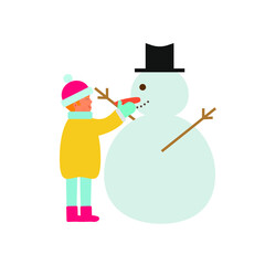 boy in the snow making a snowman