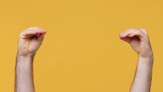 Cropped close up man male showing talking to each other two hands gesture isolated on yellow background studio. Copy space commercial promo advertisement Advertising workspace mock up place for text