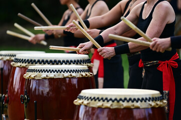 Taiko drummers drumming on Japanese Drums