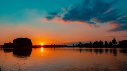 Obraz premium Beautiful sunset with reflections near Mettenufer, Danube, Bavaria, Germany