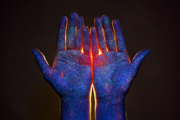 Light through the palms of your hands in ultraviolet, God and religion. Divine light through hand...