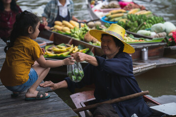 Local Market people in asia .Asian tourists local markets. Floating market It is famous in Thailand called Tha Kha Floating Market in Samut Sakhon Province	