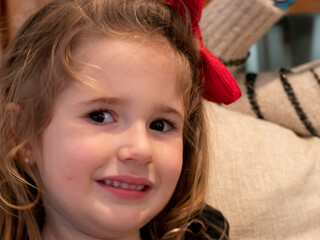 Obraz na płótnie Canvas Close-up of lovely smiling preschool girl looking at camera