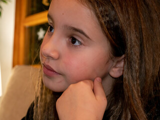 Close-up of lovely smiling preschool girl looking at camera