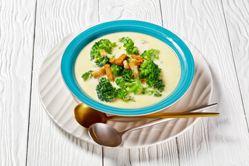 cream soup with broccoli and croutons in a bowl