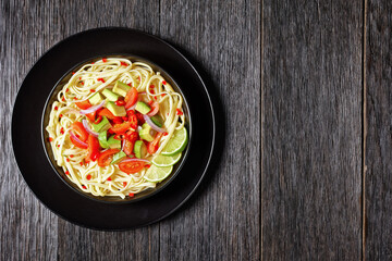 pasta with avocado, tomatoes and lime, top view