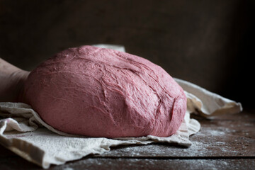 Pink beet root bread dough, dark background
