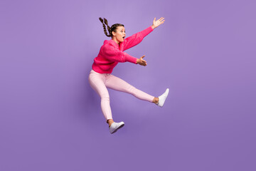 Full size profile side photo of young attractive beautiful girl jumping look copyspace catching isolated on purple color background