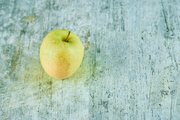 Fresh juicy green apple isolated on a marble background