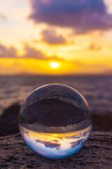 glass ball on the beach at sunset