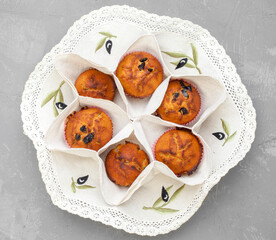 Blueberry muffins with powdered sugar and fresh berries