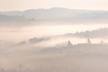 Fototapeta na wymiar Landscape with hills in soft light and fog