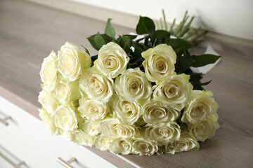 Luxury bouquet of fresh roses on commode