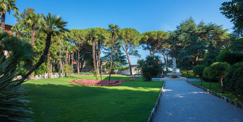 Obraz premium spa garden Opatija, Croatia with walkway, palm trees and fountain
