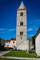Fototapeta na wymiar Bell tower of the Church of St Anselm from 12th century, Nin, a historic town in the Zadar County, Dalmatia, Croatia