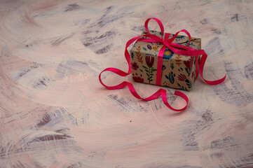Holiday package. A handmade gift.  Red ribbon.