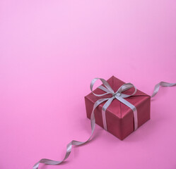 Holiday package. A handmade gift. Grey ribbon.