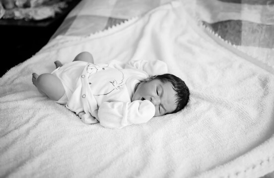 Newborn boy on his first day. Black and white photo