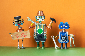 Sorry, we are closed. Service works maintenance and repair concept. Technician robotics workers with tools: hammer hand wrench pliers. Robot boss holds poster with handwritten apologizing message.